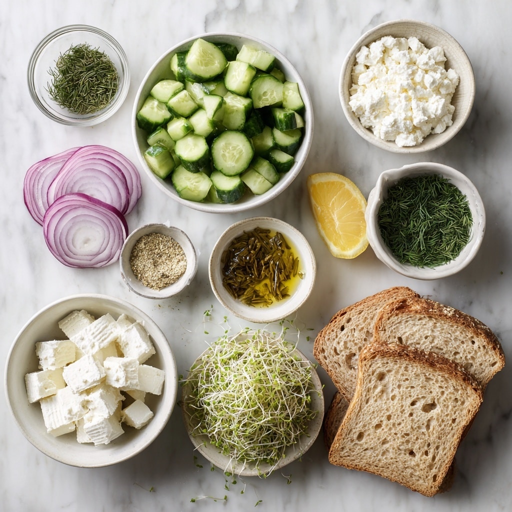 The image shows a sandwich with two layers of golden-brown toasted bread, each piece thick and crispy. Between the slices, there is a creamy salad mixture with a white base, filled with light green cucumber chunks, small pieces of purple onion, and finely chopped dark green herbs giving it a fresh and creamy texture. The sandwich is placed on a white plate with a slightly raised edge, and some green sprouts are scattered on the plate and around the sandwich, adding a fresh touch. The background is a white marbled texture. Photo taken with an iphone --ar 4:5 --v 7