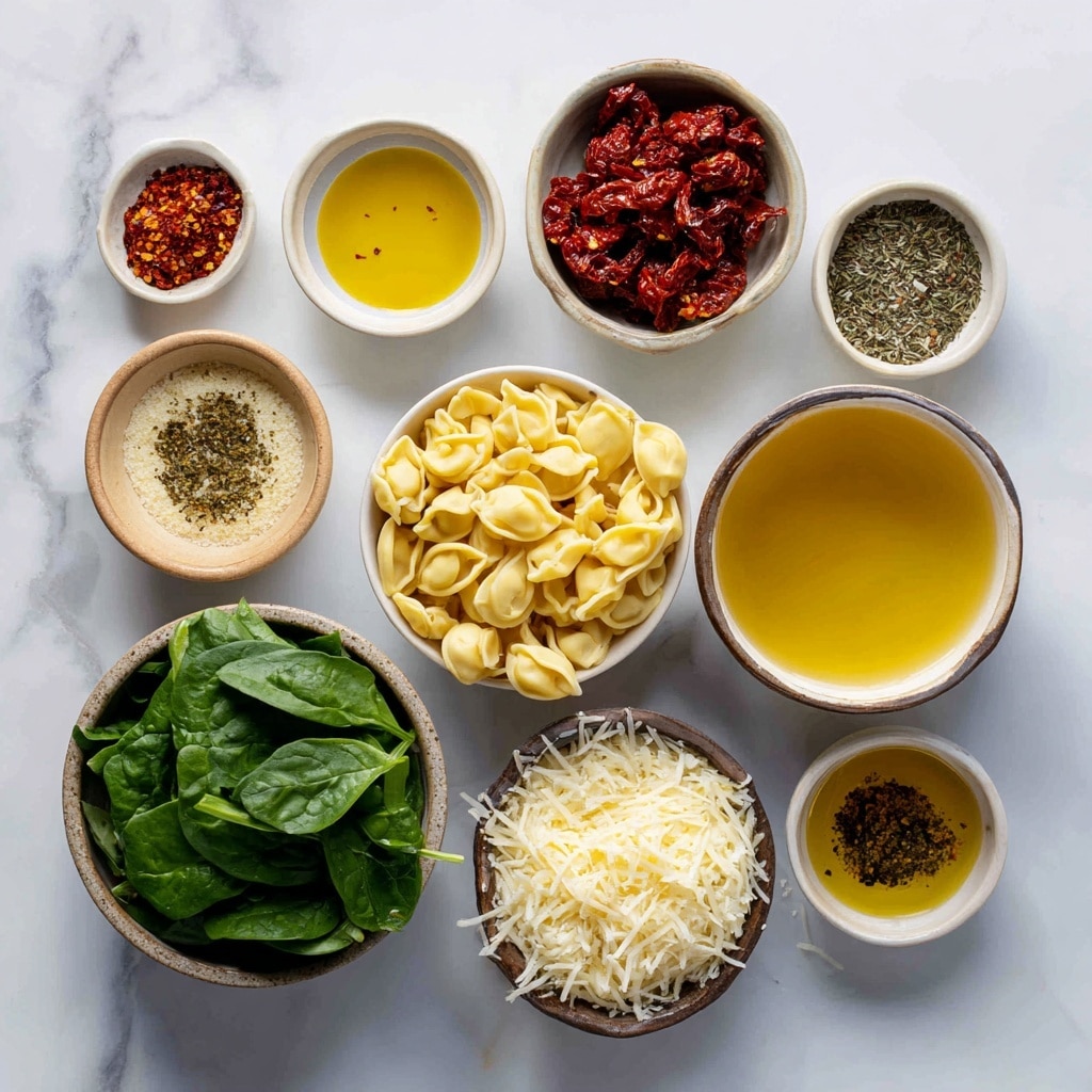 A black pan filled with creamy orange sauce mixed with green spinach leaves and small chunks of red tomatoes, topped with around thirty yellow tortellini pasta pieces scattered across the surface, sprinkled with grated cheese and black pepper; a silver spoon scoops some sauce and pasta from the right side of the pan, all placed on a white marbled surface with a beige cloth and fresh green spinach leaves nearby. photo taken with an iphone --ar 4:5 --v 7