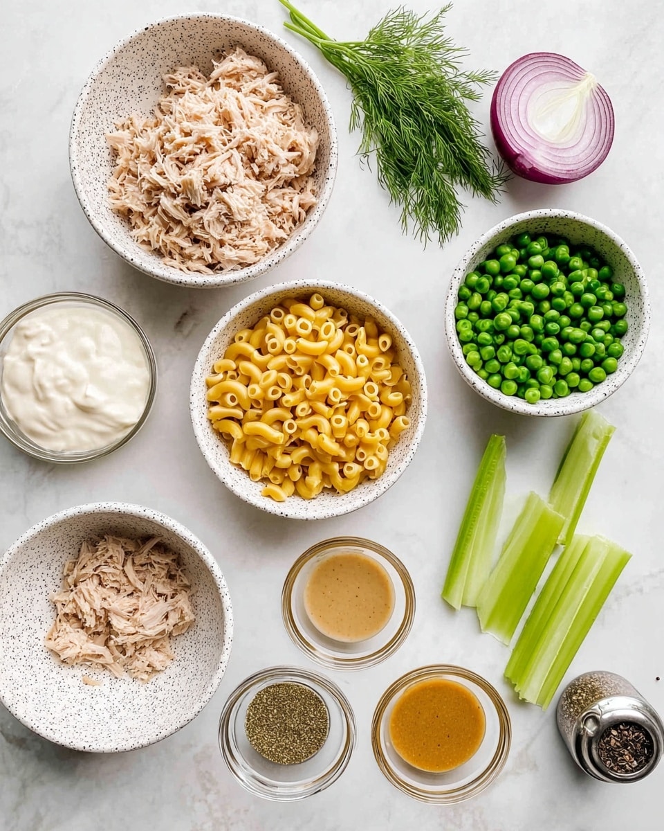 The image shows a top view of ingredients placed on a white marbled surface. There are three white bowls with black speckles: one filled with shredded light beige tuna flakes, another with small yellow elbow macaroni, and the third with frozen green peas. A white bowl holds a smooth white creamy ingredient, while another plain white bowl contains a light tan creamy substance. Several small, clear glass bowls hold various sauces and seasonings in shades of light brown, mustard yellow, and light beige. Fresh green celery sticks and a halved red onion with white inside rest nearby, along with a small bunch of fresh green dill. A small metal container with black and white pepper is also present. The items are neatly arranged in a loose circle. Photo taken with an iphone --ar 4:5 --v 7