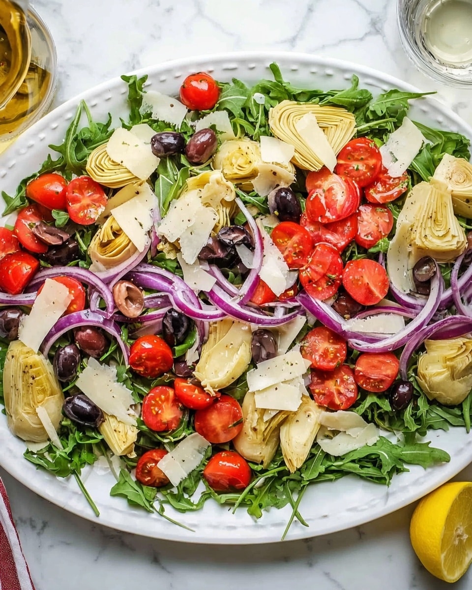 A white bowl filled with a mixed pasta salad showing three main layers. The bottom layer has farfalle pasta with light cream color and smooth texture. The middle layer has sliced bright red cherry tomatoes, light yellow artichoke hearts, black olives, and white beans scattered evenly around. The top layer consists of green arugula leaves mixed throughout, adding a fresh touch. The bowl is placed on a white marbled surface with a small bunch of red cherry tomatoes and some lemon wedges around. Photo taken with an iphone --ar 4:5 --v 7
