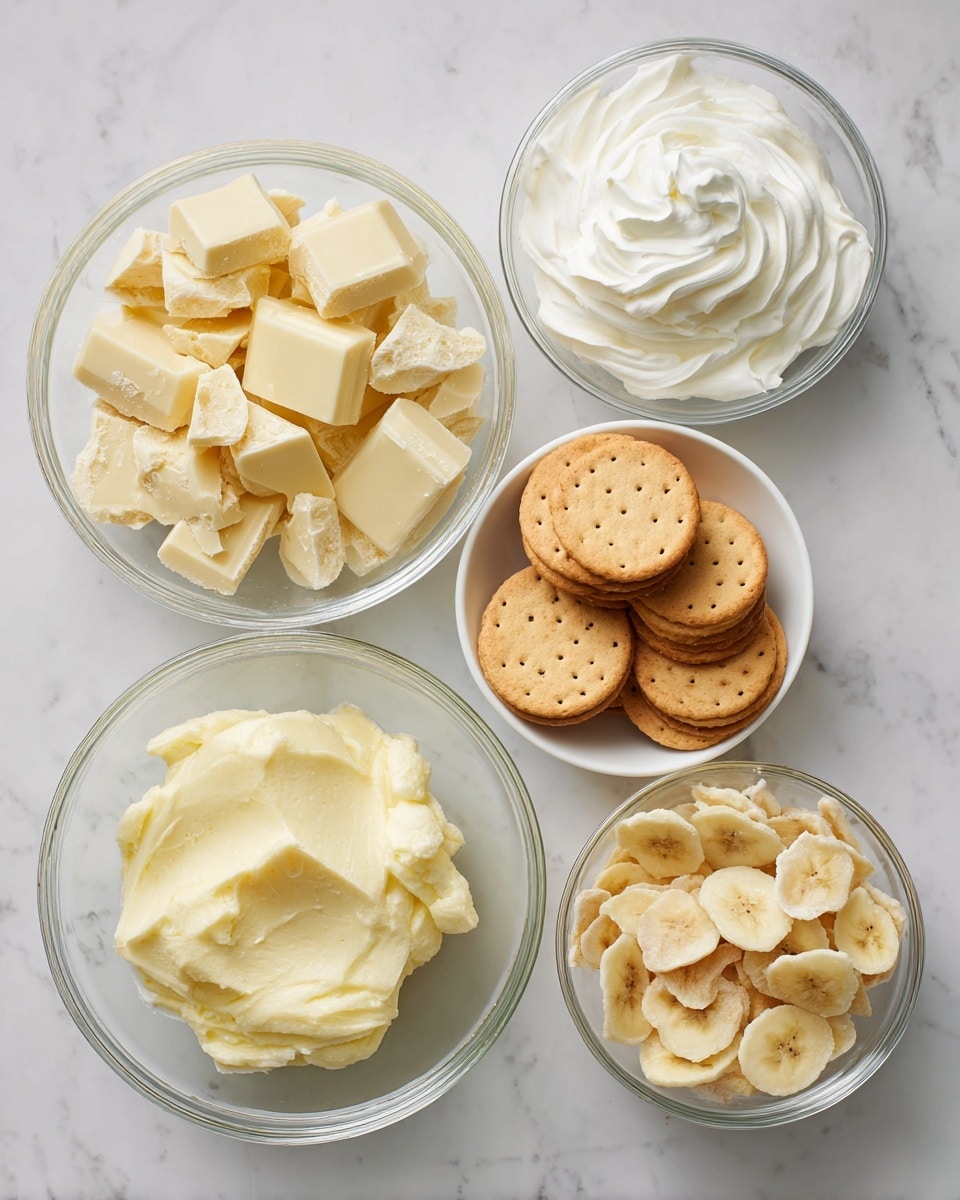 The image shows five clear glass bowls arranged on a white marbled surface. The top left bowl is filled with broken white chocolate pieces, displaying a pale yellow color and a rough texture. To its right, a bowl contains smooth, fluffy cream cheese with a pure white color and soft swirls on top. Below the white chocolate bowl, a white bowl holds round vanilla wafers that are golden brown with a crisp texture, stacked closely together. Near the right side, a smaller bowl is filled with dried banana chips, which are light yellow with some brown spots and a thin, crunchy texture. At the bottom, a bowl contains ripe mashed banana, which is a soft, pale yellow with some small chunks visible. The bowls form a loose cluster on the marbled surface. photo taken with an iphone --ar 4:5 --v 7