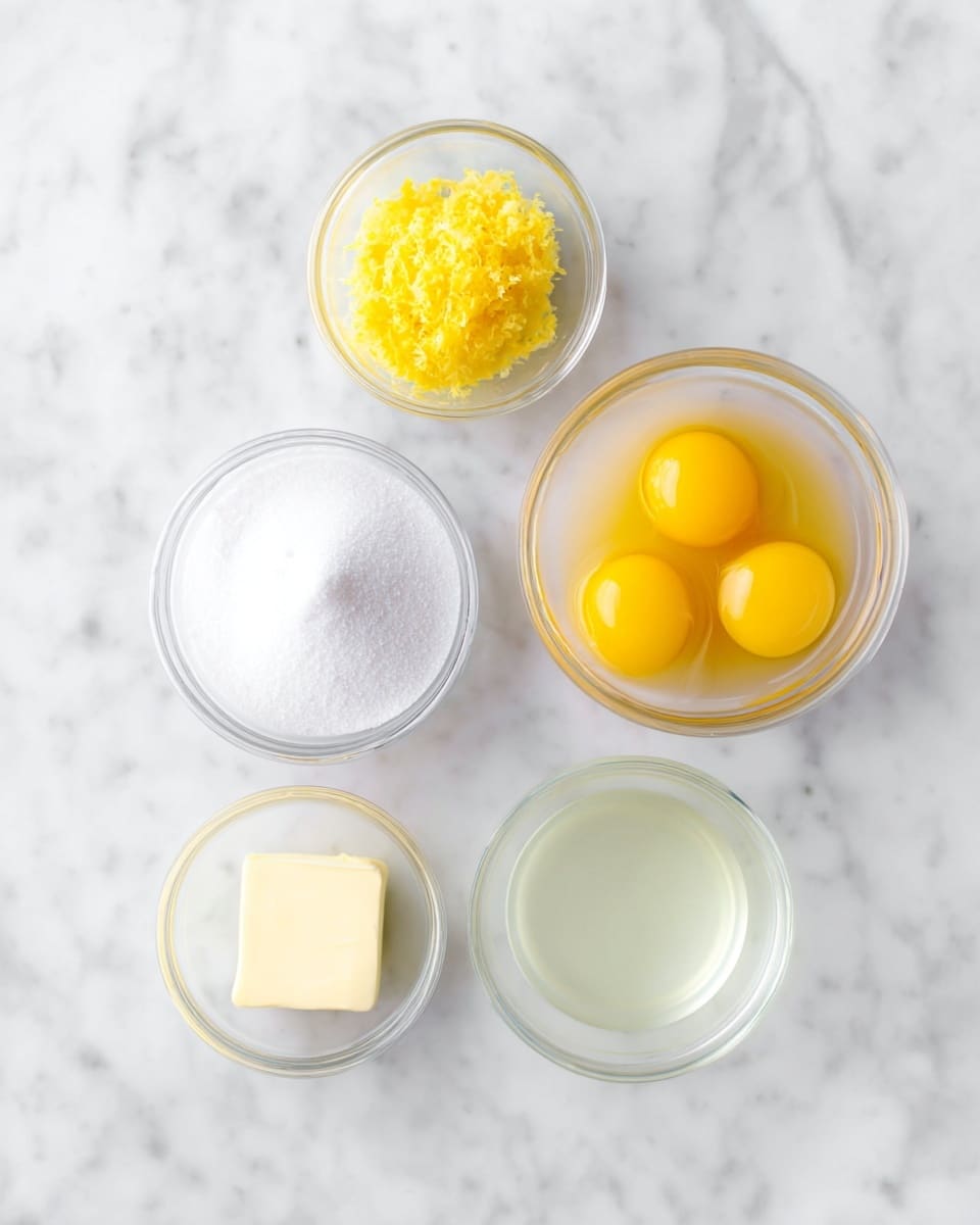 Five small clear glass bowls sit on a white marbled surface. The top left bowl holds bright yellow lemon zest with a fine texture. To the right, a bowl contains three bright yellow egg yolks smooth and glossy. Below the lemon zest, there is a larger bowl filled with fine white sugar, smooth and bright. At the bottom left, a bowl has a small solid piece of pale yellow butter. The bottom right bowl contains clear, slightly cloudy lemon juice. All bowls are evenly spaced in a loose circular shape, showing a clean and fresh setup. Photo taken with an iphone --ar 4:5 --v 7