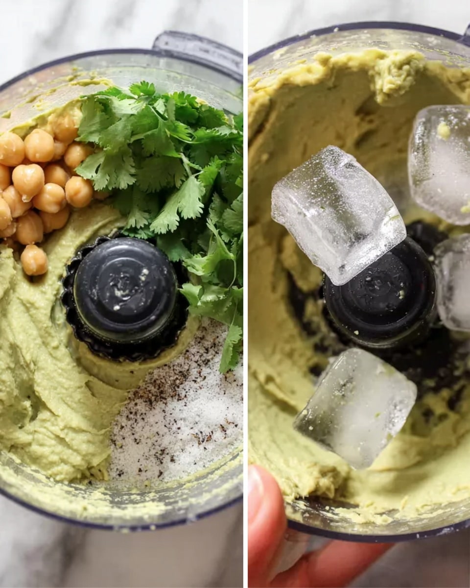 The image shows two close-up views of a food processor filled with creamy light green avocado paste, mixed with coarse white salt, black pepper, light beige chickpeas, and fresh green cilantro leaves placed on top. In the second view, a woman's hand is dropping large, clear ice cubes into the mix, while the black food processor blade is visible in the center, swirling through the creamy paste. The background is a white marbled texture. Photo taken with an iphone --ar 4:5 --v 7