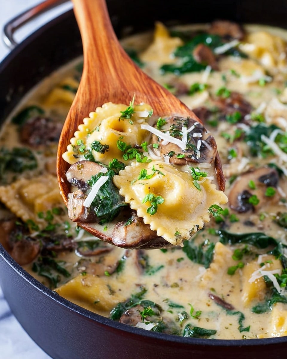A close-up view of a wooden spoon filled with a creamy soup that includes three main layers: light yellow ravioli pasta with ruffled edges, dark brown mushroom pieces, and bright green spinach leaves, all mixed in a thick, pale cream broth. The soup inside a black pot contrasts with the wooden spoon, and the dish is garnished with small green herb leaves and thin white cheese shreds on top. The background surface is a white marbled texture. photo taken with an iphone --ar 4:5 --v 7