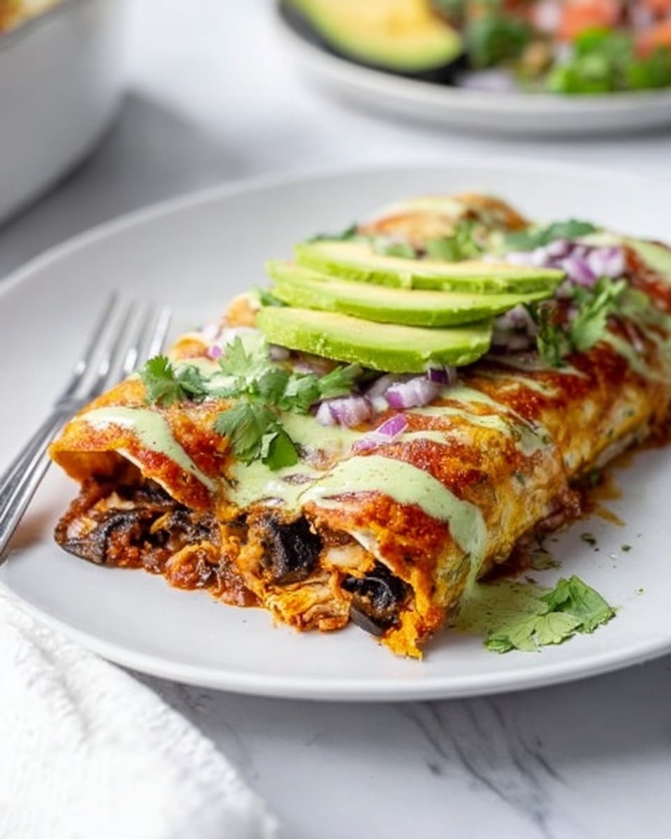 A white plate holds a rolled enchilada with three visible layers: the outer tortilla is golden and slightly crispy with melted cheese on top, sprinkled with small pieces of red onion and fresh cilantro leaves. Inside, dark mushrooms and shredded chicken mix with a reddish sauce, creating a rich texture. The top of the enchilada is drizzled with a light green sauce and crowned with three slices of fresh avocado. The background shows a white marbled surface with a silver fork beside the plate and parts of other dishes blurred out. Photo taken with an iphone --ar 4:5 --v 7