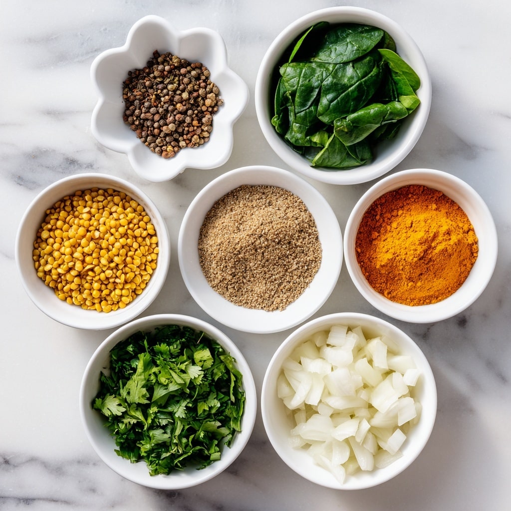 Seven white bowls are arranged on a white marbled surface, each filled with different ingredients. At the top center is a flower-shaped bowl with four spices: dark brown cumin seeds on the left, bright orange chili powder on the right, yellow turmeric below cumin, and pale ajwain/carom seeds below chili powder. Below this bowl, in the middle right, is a bowl of ground flax seed powder, light brown and finely textured. To the left of it is a bowl of chopped green chillies, dark green and moist. Below these are three white bowls in a row: chopped fresh cilantro with a leafy green texture on the right, yellow moong dal with a round, grainy look on the left, and diced onions with a white, crisp appearance in the middle. Above the bowl of onions, at the upper left, is a bowl of fresh spinach leaves, dark green and leafy. Photo taken with an iphone --ar 4:5 --v 7
