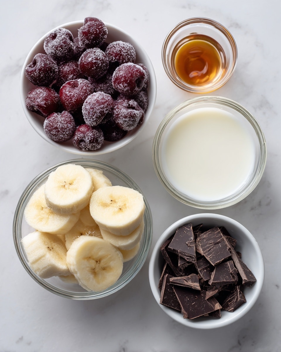 The image shows five small white bowls and glass containers arranged on a white marbled surface. The top bowl is filled with dark red frozen cherries with a frosty texture. Below it on the left is a glass bowl filled with round slices of frozen bananas, pale yellow with a firm texture. To the right of the bananas is a glass container holding smooth, white coconut milk. Below, on the left, is a small clear glass container with amber-colored vanilla extract. Finally, on the bottom right is a white bowl filled with small, broken pieces of dark chocolate, almost black in color with a rough texture. The scene is bright and clean, captured in natural light, photo taken with an iphone --ar 4:5 --v 7