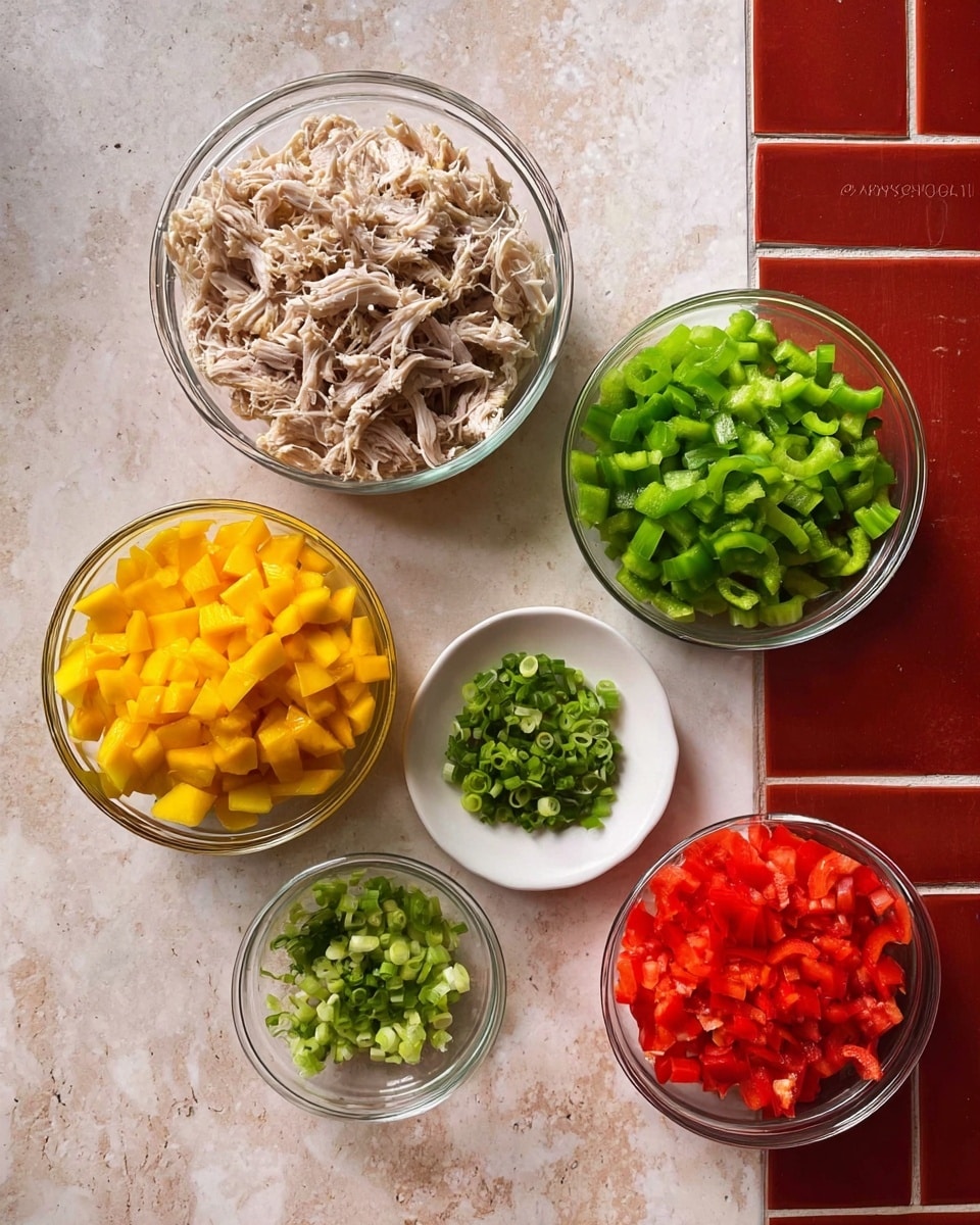 The image shows five clear glass bowls and one white plate arranged on a white marbled surface with red tile texture. The largest bowl at the top center contains shredded light beige meat. To the right, a white plate holds bright green chopped celery in curved pieces. Below the large bowl on the left side, there is a bowl with yellow diced mango pieces. To the right of this, a smaller bowl holds finely chopped red bell pepper. Below these two, a small bowl contains chopped green onions, with round, bright green and white pieces. The colors are clear and vibrant, and the bowls and plate create a neat organized look photo taken with an iphone --ar 4:5 --v 7