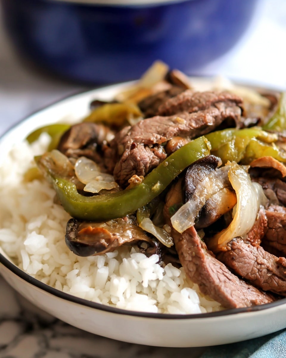 A close-up view of a white bowl filled with white rice at the bottom layer, topped with a mix of cooked beef strips, light brown cooked onions, dark brown mushrooms, and green bell peppers, all mixed together and piled loosely on top. The beef has a tender texture, and the vegetables appear soft and slightly translucent. The bowl sits on a white marbled surface with a blurred blue bowl in the background. photo taken with an iphone --ar 4:5 --v 7