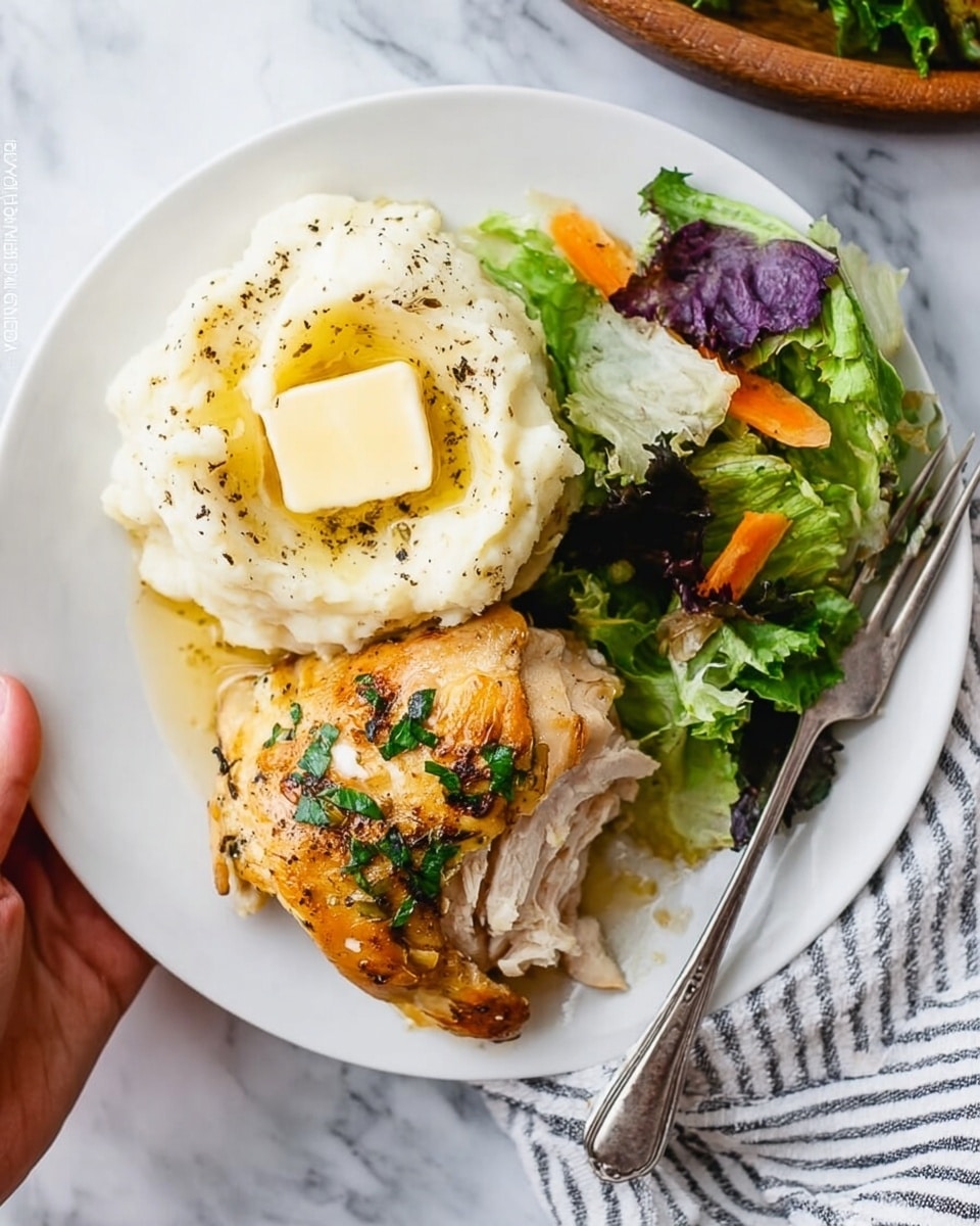A white plate holds a meal with three main parts arranged side by side. On the left, there is a creamy mashed potato layer topped with a square of melting butter and sprinkled with black pepper, smooth in texture. In the center, a golden-brown cooked piece of chicken with some fresh green herbs on top has a few slices partially lifted, showing white juicy meat inside. On the bottom right of the plate, there is a fresh salad layer with torn lettuce leaves, some purple cabbage, and a few small carrot strips, adding a mix of green, purple, and orange colors. A silver fork rests vertically on the right edge of the plate, on a white marbled surface with a striped cloth nearby. A woman's hand is just visible holding the plate from the top left corner. Photo taken with an iphone --ar 4:5 --v 7