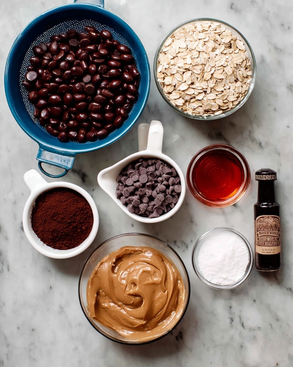 The image shows seven bowls and a bottle arranged on a white marbled surface. Starting from the top left, there is a blue colander filled with shiny dark brown beans. Below it to the left, a small white bowl holds a fine dark brown powder, likely cocoa. To the right of the powder bowl, there is a white measuring cup filled with many small dark brown chocolate chips. Below these two, another white measuring cup contains pale beige rolled oats. Next to it on the right is a clear glass bowl filled with smooth, light brown peanut butter. Moving back upward, a small clear glass bowl holds a transparent liquid with a reddish tint, likely maple syrup. Above it is another small clear glass bowl filled with white granulated sugar. Lastly, to the right is a small dark-colored bottle labeled Mexican pure vanilla extract. The arrangement is neat and the colors contrast well. Photo taken with an iphone --ar 4:5 --v 7