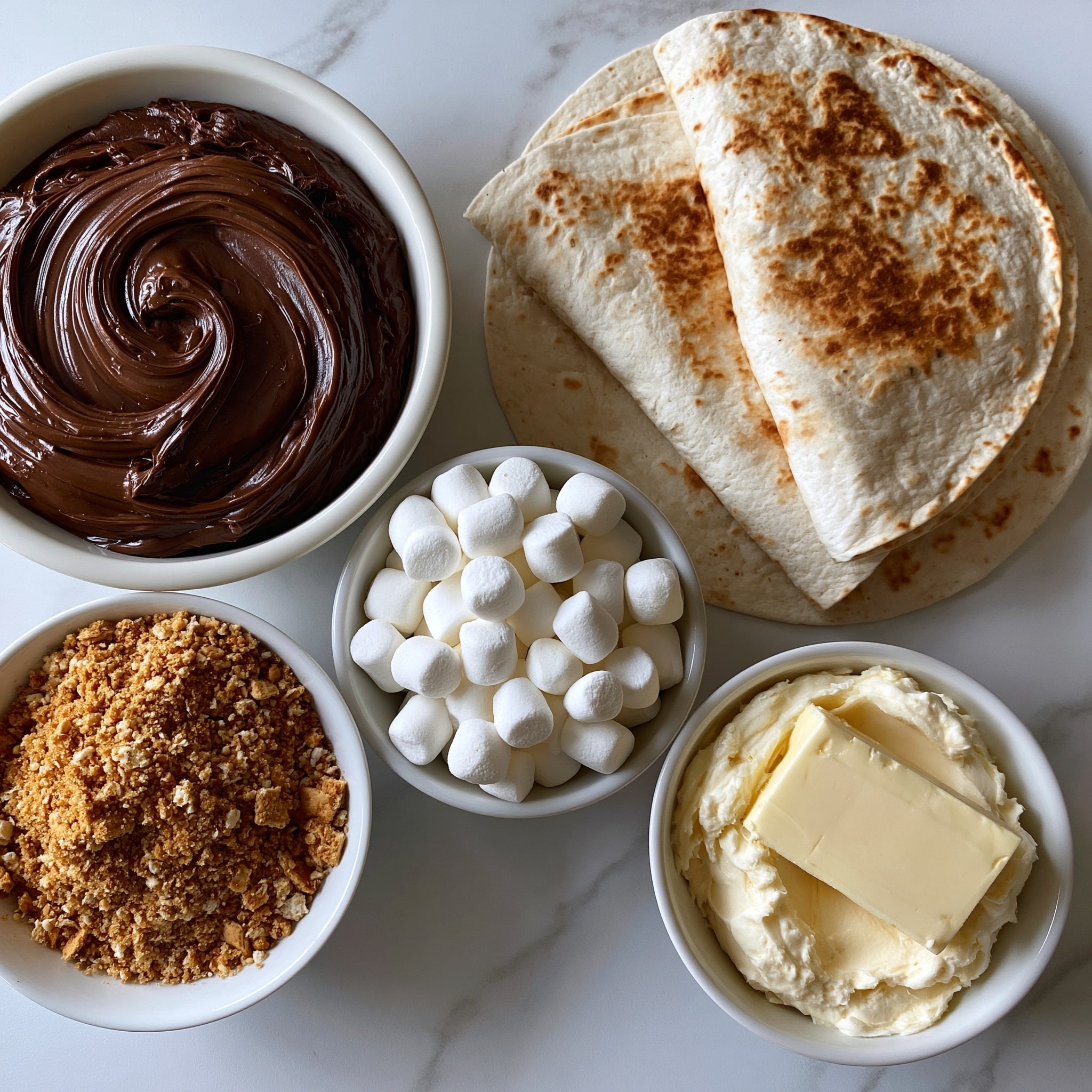 The image shows a sandwich with two layers of folded white flatbread, each layer filled with melted brown chocolate and small white marshmallows. The chocolate looks thick and creamy, oozing out from the edges. The top flatbread is sprinkled with a light dusting of brown powder, likely cinnamon or cocoa. The sandwich is placed on a wooden cutting board with a white marbled background. Around the sandwich, there are scattered white marshmallows and a wooden spoon with melted chocolate on it, with a jar of chocolate spread blurred in the background. Photo taken with an iphone --ar 4:5 --v 7