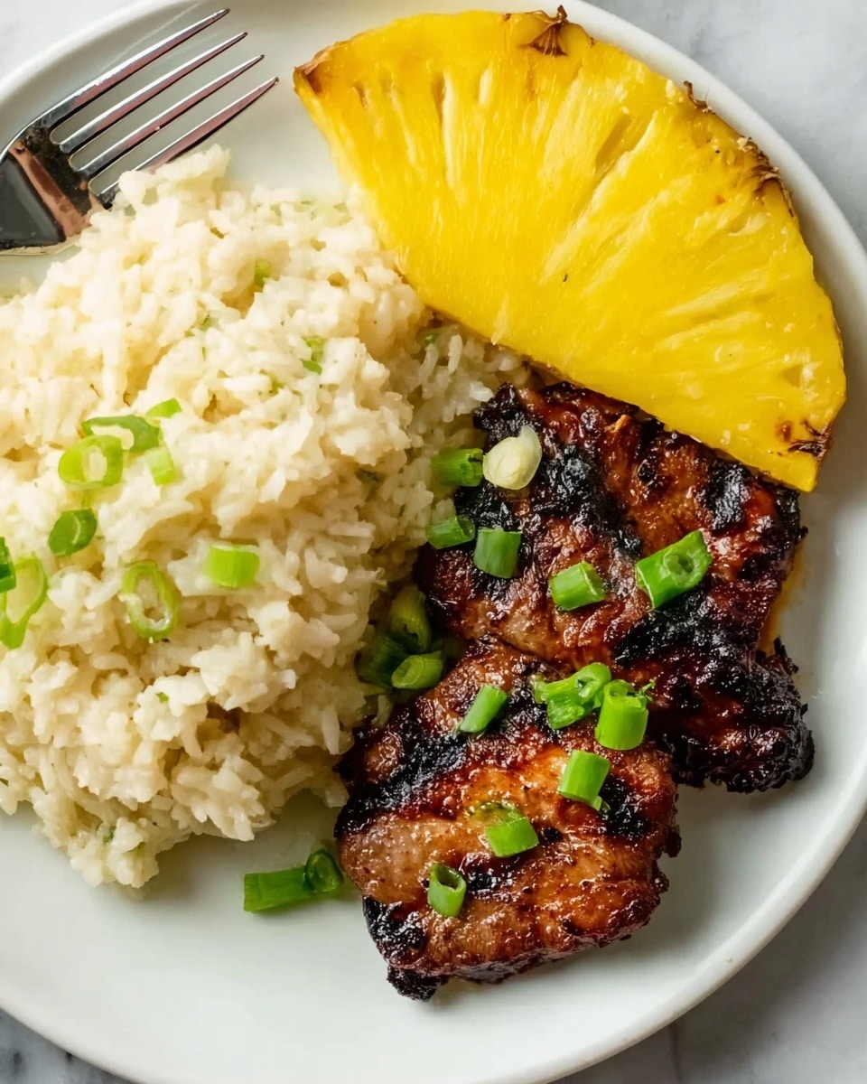 The image shows a close-up of a white plate with three main parts: on the left side, there is a soft, creamy mound of light-colored rice with small bits of green onion on top; in the bottom right corner, there are two grilled pieces of dark brown meat with char marks and garnished with green onion bits; at the top right corner, there is a thick wedge of bright yellow pineapple. A silver fork is placed on the top left edge of the plate, resting on the food. The plate sits on a white marbled surface. photo taken with an iphone --ar 4:5 --v 7