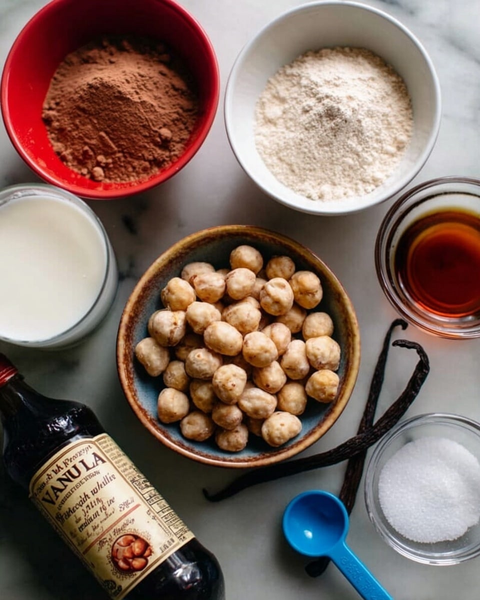 The image shows a close-up of several ingredients arranged on a white marbled surface. In the center is a small bowl filled with round, light brown nuts with a slightly wrinkled texture. Above it, there is a white bowl with light brown powder, likely cocoa powder. To the right, a white bowl contains a dark amber liquid, possibly vanilla or syrup. On the left side, a red bowl filled with a white liquid, probably milk, sits next to a small glass bowl holding white granulated salt. Below these, a bottle of pure vanilla extract is tilted to the side, showing its label clearly. A blue measuring spoon rests near the bowl with nuts, adding to the arrangement. The overall look is simple and neat with natural colors and textures. photo taken with an iphone --ar 4:5 --v 7