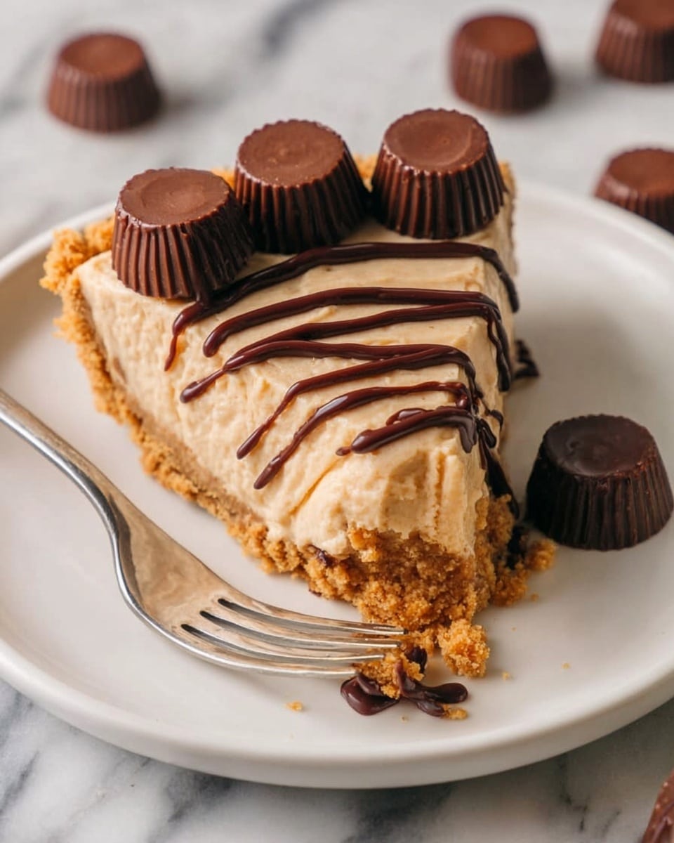 A slice of creamy light brown pie sits on a white plate with a crumbly, golden crust at the bottom. The top of the pie slice is decorated with three small, round chocolate cups placed in a row, and drizzled with smooth, dark chocolate sauce in thin, wavy lines. Next to the pie slice is a white fork holding a piece of the pie with some chocolate sauce on it. Around the plate are more small chocolate cups. The plate rests on a white marbled surface. Photo taken with an iphone --ar 4:5 --v 7