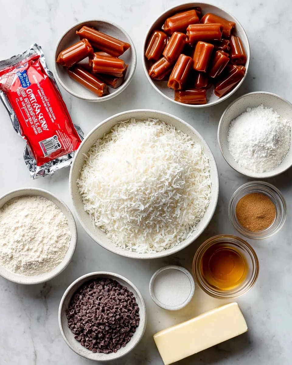A flat lay image shows several white bowls and dishes arranged on a white marbled surface, containing ingredients for a recipe. The largest bowl in the center is full of finely shredded white coconut. To the top right, another white bowl is filled with brown caramel candies, slightly shiny and rolled. Surrounding these are smaller bowls holding white sugar, flour, milk, and powdered sugar. A stick of unsalted butter wrapped in paper lies near the bottom right. A small glass bowl contains a golden brown liquid, likely vanilla extract. A bright red package of dark chocolate melting wafers is placed to the left side. The colors in the image are mainly white, brown, and red, with a clean and organized look. Photo taken with an iphone --ar 4:5 --v 7