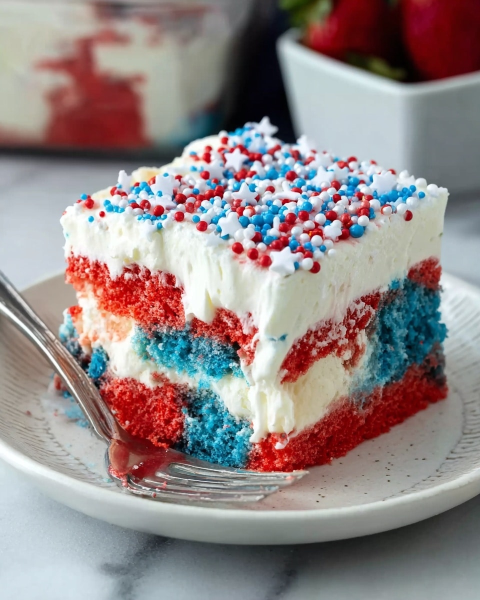 A square piece of layered cake sits on a white plate with a subtle pattern, placed on a white marbled surface. The cake has three main layers: the bottom layer is a mix of bright red and blue sponge cake with a soft, crumbly texture; the middle layer is a smooth, creamy white filling that slightly drips down into the sponge layer; the top layer is thick and white frosting decorated with small round sprinkles in red and blue, along with small white star-shaped sprinkles spread evenly across the surface. The cake has a bite taken from one corner, showing the layers inside clearly. A silver fork rests in front of the plate, and in the background, there is a slightly blurred container of strawberries. photo taken with an iphone --ar 4:5 --v 7